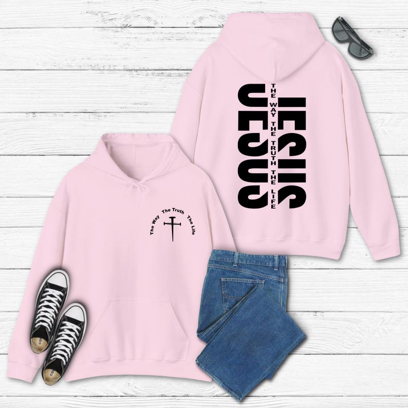 May include: Pink hoodie with a cross and the words "The Way, The Truth, The Life" on the front and the word "JESUS" vertically on the back.