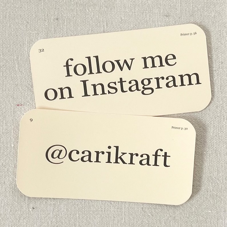 May include: Two cream-coloured cards with black text. The top card says "follow me on Instagram". The bottom card says "@carikraft".