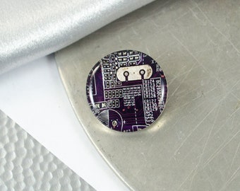 May include: A round, purple and white circuit board encased in clear resin. The circuit board has text on it, including "BC295BC296BC", "ER124", "ER123", "ER126", "ER125", "ER128", "ER127", "ER129", "ER130", "ER122", "R756", "R763", "R761", "R758", "R759", "R762", "R760", "R757", "R6", "RR", "C266", "436587", "22222", "232", "80".