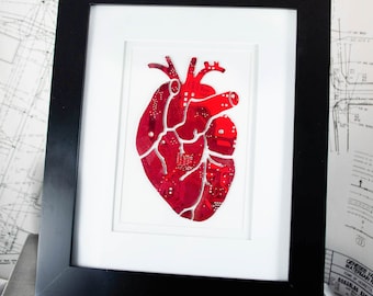May include: A framed print of a red anatomical heart made from circuit board pieces.