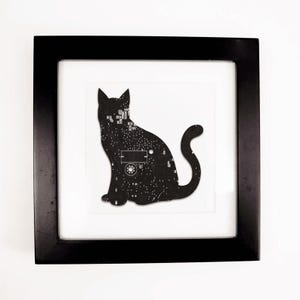 May include: Framed artwork with a black cat silhouette filled with a circuit board pattern. The print is set within a black frame and a white mount. The cat is sitting.
