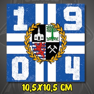 May include: Square sticker with a blue and white design featuring the numbers "1904". The center has a crest with a church, tree, lion, and crossed tools, surrounded by a gold wreath. The sticker measures 4.1 x 4.1 inches.