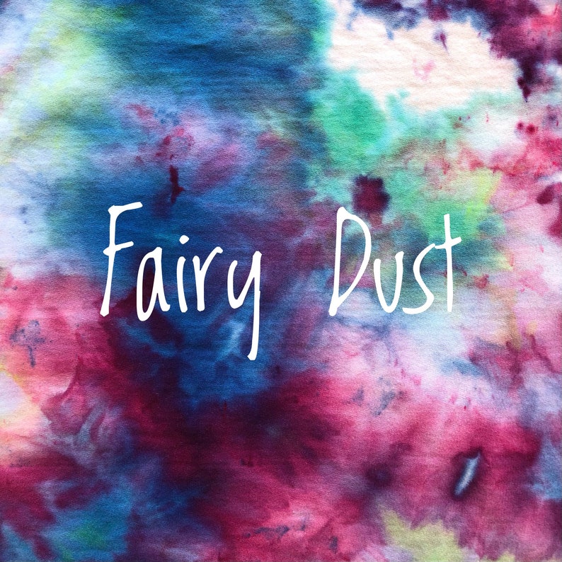 May include: A tie-dye fabric background with the words "Fairy Dust" written in white.