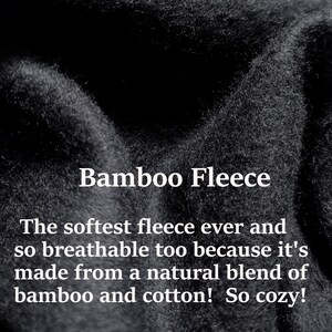 May include: Close-up of a soft, black fabric with the text "Bamboo Fleece" and the description "The softest fleece ever and so breathable too because it's made from a natural blend of bamboo and cotton! So cozy!"