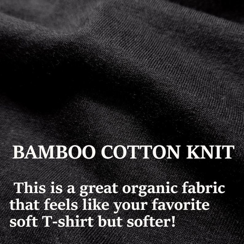 May include: Close-up of a black, soft, and textured fabric. The fabric is labeled "BAMBOO COTTON KNIT" and described as a great organic fabric that feels like your favorite soft T-shirt but softer!