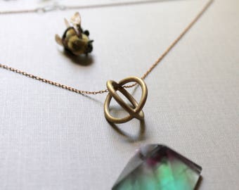 Trapped // round brass cage necklace