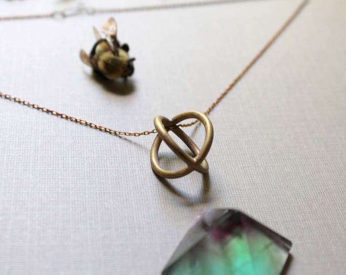 Trapped // round brass cage necklace