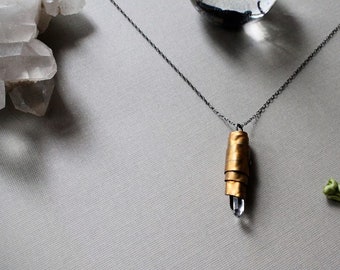 Cocoon // raw clear quartz wrapped in brass necklace