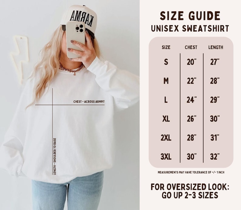 May include: A white unisex sweatshirt size guide featuring a chart with chest and length measurements in inches from S to 3XL. The graphic includes text labels for chest across armpit and length from shoulder to base, noting a 1-inch tolerance.