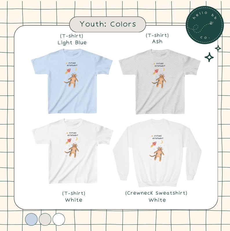 Peut inclure: T-shirts et sweat-shirt pour enfants avec un tigre en dessin anim&eacute; portant une combinaison spatiale et tenant une fus&eacute;e. Les t-shirts sont disponibles en bleu clair, gris et blanc. Le sweat-shirt est blanc.