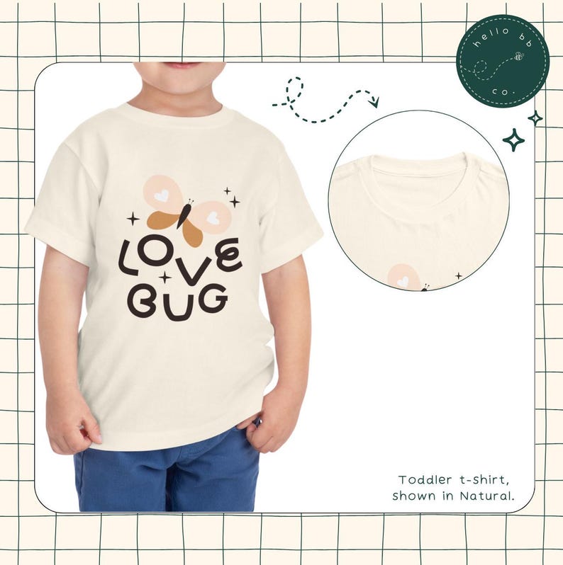 May include: A toddler wearing a white t-shirt with a butterfly graphic and the text "LOVE BUG" in brown and black lettering. The shirt is shown in the color Natural.
