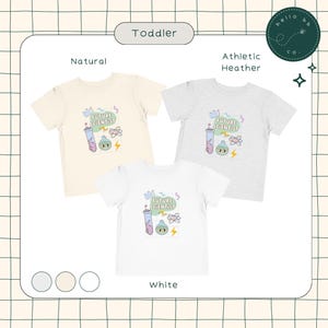 May include: Three toddler t-shirts in natural, athletic heather, and white. Each shirt features a colorful graphic with the text "FUTURE SCIENTIST", a beaker, an atom, and a lightning bolt.