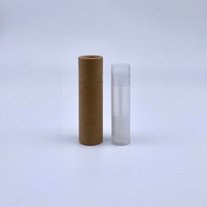 May include: A brown cardboard tube and a clear plastic tube, both cylindrical in shape. The tubes are empty and appear to be for lip balm or other similar products.