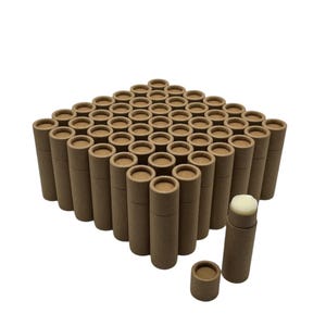 May include: A bulk pack of 50 brown cardboard tubes, perfect for packaging lip balm, salves, or other small items. The tubes are arranged in a square formation, with one tube open and showing a white balm inside.