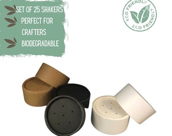 May include: Set of 25 biodegradable paper shakers in brown, black, and white. The shakers have small holes in the top. The text "Set of 25 Shakers, Perfect for Crafters, Biodegradable" is visible in the image. The text "Eco Friendly" is in a circle with a green leaf design.