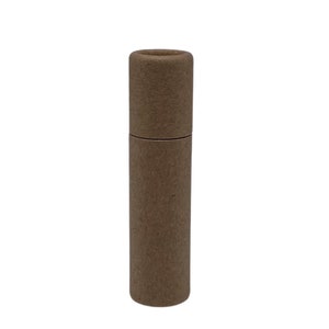 May include: A brown cardboard tube with a round opening at the top. The tube is about 6 inches tall and 1 inch in diameter.