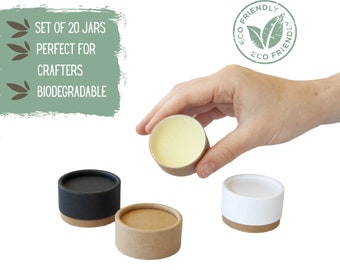 May include: Set of 20 small, round, biodegradable jars with lids. The jars are shown in black, white, and brown. The jars are perfect for crafts.
