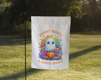 May include: A white garden flag with a rainbow-colored ghost and pumpkins. The text on the flag reads "Spooky Nights & Queer Rights".