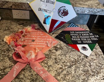 May include: Three graduation caps with decorative elements. One cap features the text "CSM ALL HATERS I GRADUATED" and the Mexican flag. Another cap has a pink ribbon with "Karina" and "Class of 2025". The third cap has the American flag and Spanish text.