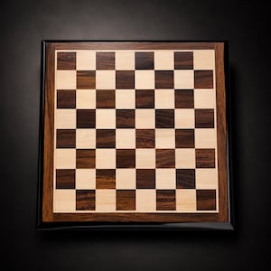 May include: A square wooden chessboard featuring a classic alternating grid of light cream and dark brown wood grain squares. The board is framed by a wide border of dark wood and finished with a smooth, glossy black outer edge on all four sides.