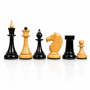 May include: A set of six Staunton-style chess pieces arranged in a row, alternating between black and light wood finishes. The collection includes a king, queen, bishop, knight, rook, and pawn, each featuring a smooth, polished surface and green felt base.