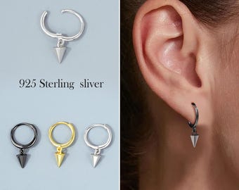 May include: Three hoop earrings with a small, pointed pendant hanging from each. The hoops are available in silver, gold, and black.