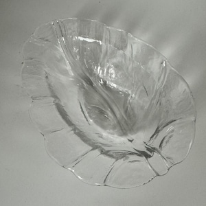 May include: A white ceramic mug with a black handle and the text "But First, Coffee" in a black, bold font. The mug is sitting on a wooden surface.