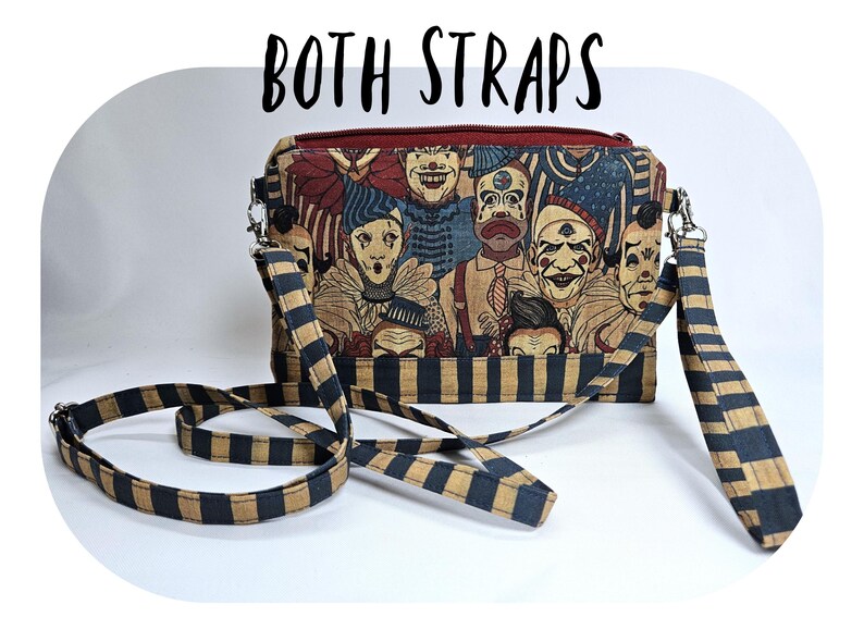 May include: A rectangular crossbody bag with a zipper closure and two straps. The bag features a print of vintage clown faces in various colors. The straps are black and tan striped. The text "BOTH STRAPS" is above the bag.