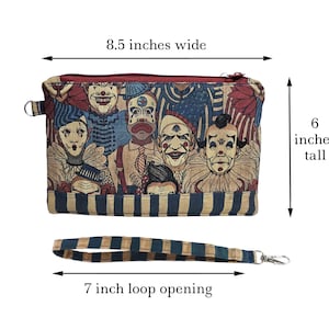 May include: A zippered clutch with a clown-themed pattern, measuring 8.5 inches wide and 6 inches tall. The wrist loop is 7 inches. The fabric features a repeating pattern of vintage-style clown faces in shades of red, blue, and beige.
