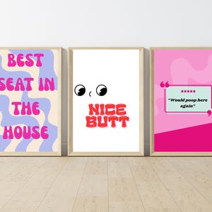 May include: Three framed art prints with humorous text. One print says "BEST SEAT IN THE HOUSE" in pink letters over a blue and white wavy background. Another says "NICE BUTT" in red letters. The third says "Would poop here again".