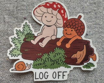 May include: A whimsical sticker featuring two cartoon characters, one resembling a mushroom and the other an acorn, sitting on a log. The sticker includes a snail and the text "LOG OFF" in a playful font, with green and brown accents.
