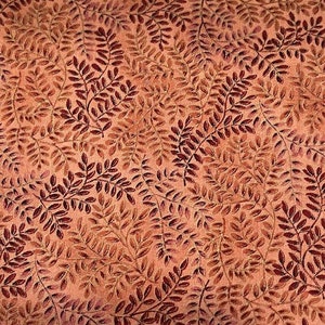May include: Close-up of a fabric with a repeating pattern of stylized leaves. The leaves are in shades of brown and burgundy against a peach-colored background. The design creates a textured, organic look.