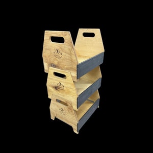 May include: A stack of three wooden storage caddies with a natural wood finish and dark gray trim. Each caddy has a handle cut out at the top and a logo that reads "Hixon Caddy". The caddies are stacked on top of each other.