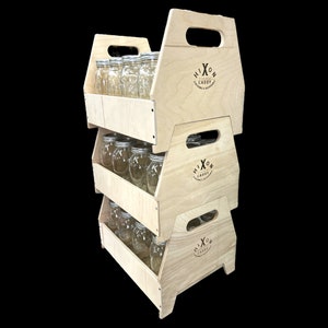 May include: A three-tiered wooden stand with a handle on each level. Each level is filled with clear glass jars. The stand is labeled "HIXON CADDY" on each level.