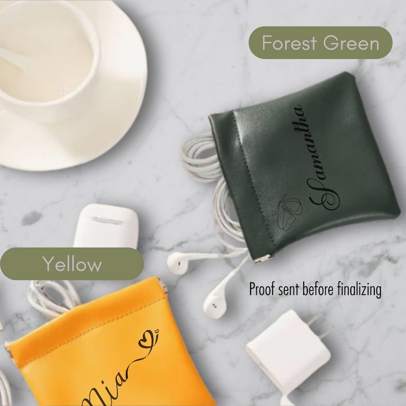 May include: Two personalised pouches for storing small items such as earbuds or charging cables. The pouch on the left is yellow with the name "Mia" and a heart design. The pouch on the right is forest green with the name "Samantha" and a butterfly design.  "Proof sent before finalizing" is written below the pouches.