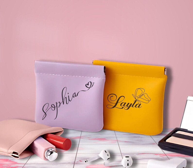 May include: Two small, personalised pouches, one purple with the name "Sophia" and a heart, the other yellow with the name "Layla" and a butterfly design.