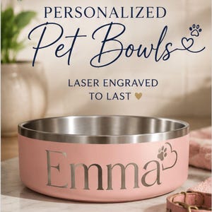 May include: A light pink stainless steel pet bowl with a silver interior. The exterior features the laser-engraved name Emma followed by a heart and paw print icon. Text above the bowl reads PERSONALIZED Pet Bowls and LASER ENGRAVED TO LAST.