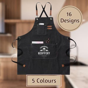 May include: Black canvas apron with adjustable straps, a large pocket, and a smaller pocket with a phone holder. The apron has a logo that says "Grill Master Geoffery Since 2002".
