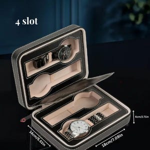 Puede incluir: Caja de reloj de cuero negro con interior beige y cuatro ranuras para guardar relojes. La caja mide 14 cm de largo, 18 cm de ancho y 6 cm de alto. La caja tiene una etiqueta de "4 slot" en la parte delantera.