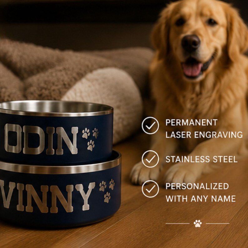 May include: Two stacked navy blue stainless steel pet bowls with silver laser-engraved names ODIN and VINNY, accompanied by paw print designs. Text on the right reads: PERMANENT LASER ENGRAVING, STAINLESS STEEL, PERSONALIZED WITH ANY NAME.