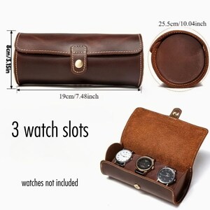 May include: A brown leather watch case with three slots, measuring 19cm long, 8cm high, and 25.5cm in diameter. The case has a button closure and white stitching. The text "3 watch slots" and "watches not included" are visible.