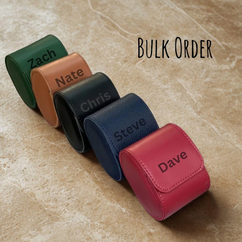 May include: A row of five leather watch cases in various colors: green, tan, black, navy, and red. Each case is personalized with a name in a contrasting color. The text "BULK ORDER" is in the background.