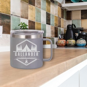 Custom engraved client appreciation mug, a premium and practical business gift for professionals, realtors, and corporate events. Insulated mug sits on kitchen counter with a custom engraved logo promoting a city.