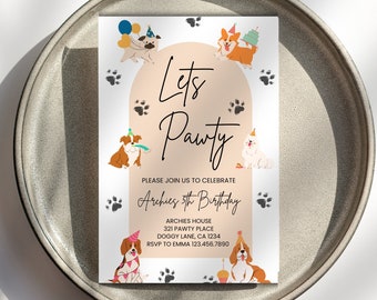 May include: A party invitation with the text "Let's Pawty" and "Archie's 5th Birthday". The invitation features illustrations of dogs with party hats and paw prints. The invitation is on a neutral background and is placed on a gray plate.