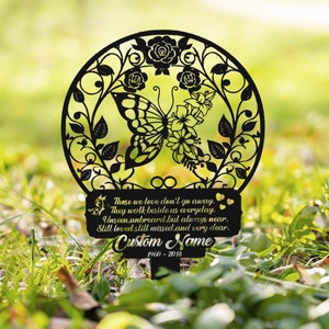 May include: Black metal garden stake with a butterfly and floral design. The stake has a sign that reads "Those we love don't go away. They walk beside us everyday. Unseen, unheard, but always near. Still loved, still missed, and very dear. Custom Name 1960-2018"