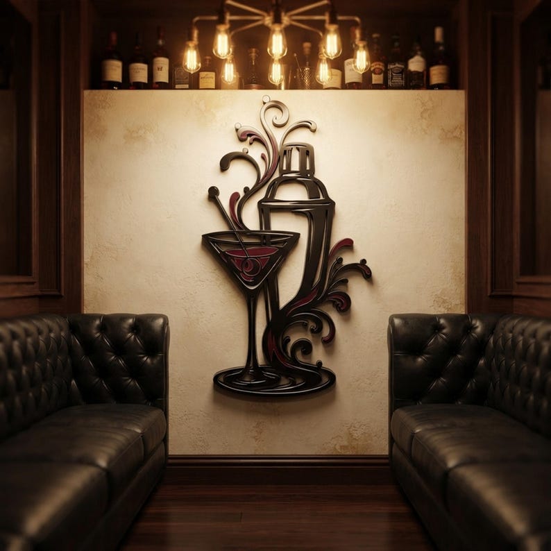 May include: A black and dark red wall art piece featuring a stylized cocktail shaker and a martini glass with swirling decorative flourishes. The design is mounted on a light-colored wall between two dark leather tufted sofas in a room.