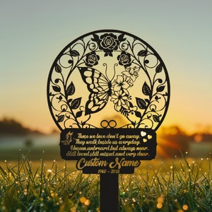 May include: Black metal garden stake with a butterfly design and a sign that reads "Those we love don't go away. They walk beside us everyday. Unseen, unheard, but always near. Still loved, still missed, and very dear. Custom Name 1960-2018"