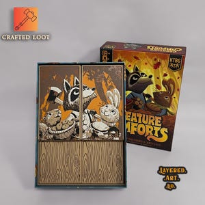 May include: A board game box set with the title "Creature Comforts" featuring cartoon animal characters. The box is brown and orange with a raccoon, rabbit, and other animals. The game box is open, revealing the game's interior.