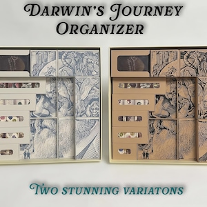 May include: Two open boxes displaying a board game organizer. The boxes are filled with small, illustrated boxes and compartments. The text "Darwin's Journey Organizer" is at the top, and "Two stunning variations" is at the bottom.