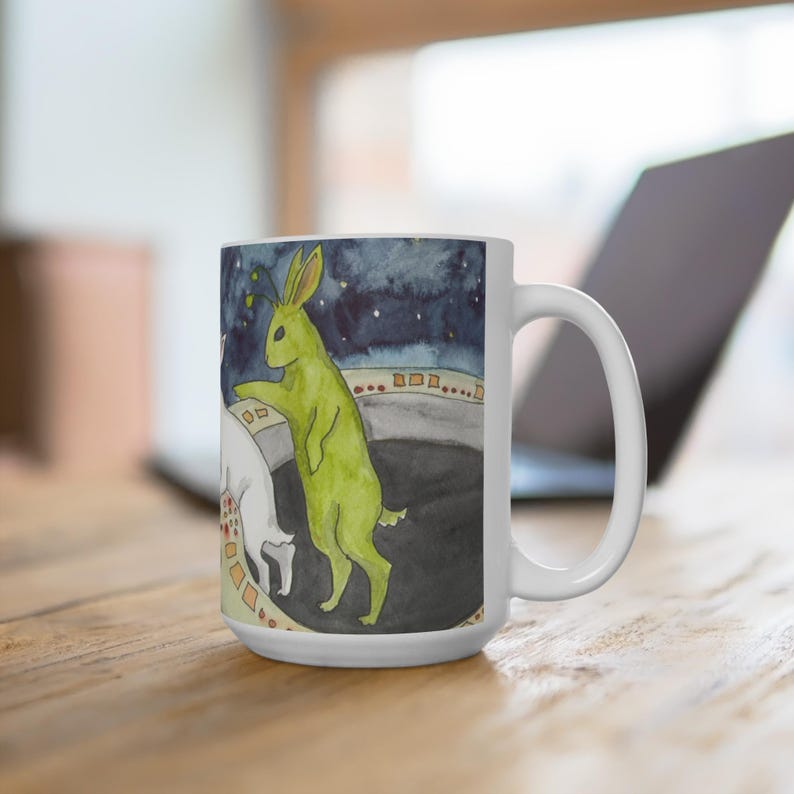 cute coffee cup mug with original art painting of a white rabbit in a space ship with a green alien bunny, art by Nakisha, watercolor art mug, alien lover mug, cute original animal art, rabbit lover gift